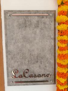 a sign for a restaurant with flowers around it at La casona in Kottayam +5 photos