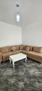 a living room with a couch and a coffee table at Summer Apartments in Shengjin in Shëngjin