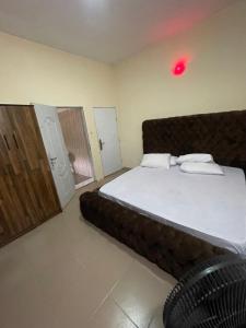 a bedroom with a large bed and a red light at 1 bedroom apartment in Awoyaya +9 photos