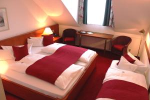 Rúm í herbergi á Hotel Blumlage