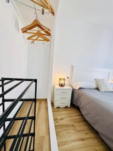 une chambre avec un lit et un parquet dans l'établissement Apartamento Essence Ronda -CENTRO CIUDAD-, à Ronda 8 autres photos