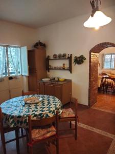 a kitchen and dining room with a table and chairs at Etna view Villa Letizia a Taormina in Taormina
