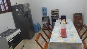 a kitchen with a table with a blender on it at Casa do Edi in Maricá