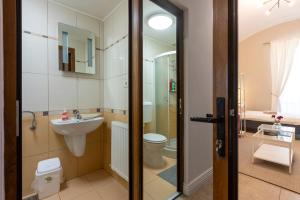 a bathroom with a toilet and a sink at #Comfy Apartment in Old Town in Timişoara