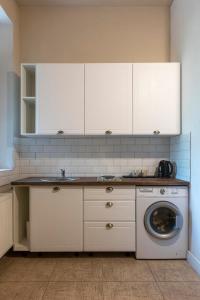 a kitchen with a sink and a washing machine at #Comfy Apartment in Old Town in Timişoara +37 photos