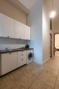 a kitchen with white cabinets and a washing machine at #Comfy Apartment in Old Town in Timişoara