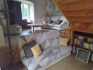 a living room with a couch and a table at chateau d'eau logement insolite in Tournemire