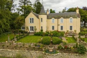a large house with a garden in front of it at Luxury 5-Bed Country Retreat in the Angus Glens in Glenogil
