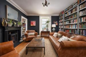 a living room with a couch and a fireplace at Luxury 5-Bed Country Retreat in the Angus Glens in Glenogil