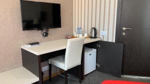 a desk with a white chair in a room at East Gate Boutique Hotel in Tbilisi City
