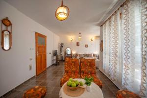 a living room with a couch and a table at Valchevi Apartments in Chernomorets