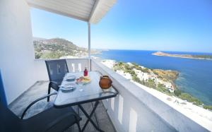 a table on a balcony with a view of the ocean at On Sight Studio l in Myrties