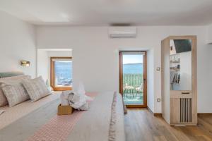 a living room with a couch and a view of the ocean at Seafront Apartment Balcony Panoramic View in Kaštela