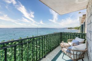 a balcony with chairs and a view of the water at Seafront Apartment Balcony Panoramic View in Kaštela