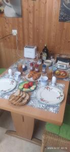 a table with plates of food and bread on it at Dom wiejski Artur in Goldingen +22 photos