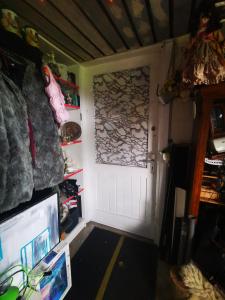 a room with a white door and a television at Den gamle smedie in Holbæk