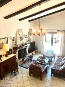 a living room with a couch and a fireplace at Petrothalassa View in Kranidi