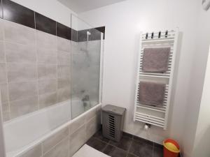 a bathroom with a shower with a glass door at DÉTENTE GARANTIE in Clermont-Ferrand +17 photos