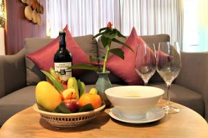 a table with a bottle of wine and a bowl of fruit at Deluxe Double Room with Patio or Balcony in Siem Reap