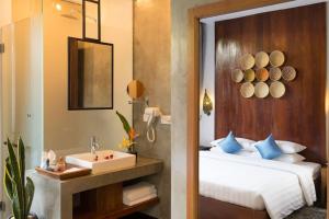 a bedroom with a bed and a sink and a mirror at Deluxe Double Room with Patio or Balcony in Siem Reap +2 photos