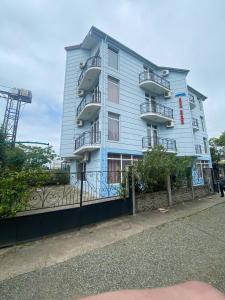 a blue building with balconies on the side of it at Sea Side in Ureki