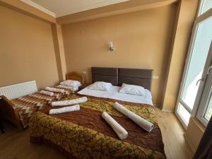 a bedroom with two beds with pillows on them at Sea Side in Ureki