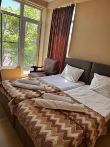 a bedroom with a bed with a chair and a window at Sea Side in Ureki