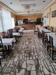 a restaurant with tables and chairs on a mosaic floor at Zajazd U Cyngla in Skopanie