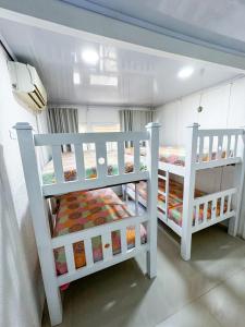 サン・アンドレスにあるIn Di Woods Houseの白い二段ベッド2台(1室)