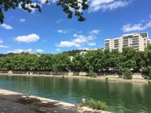 a body of water with buildings in the background at Duplex cosy-Wifi-Parking-Netflix-Lyon 9 in Lyon