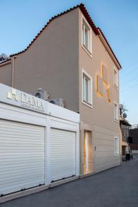 a building with two garage doors in front of it at Dama Luxury Suites Pompei in Pompei