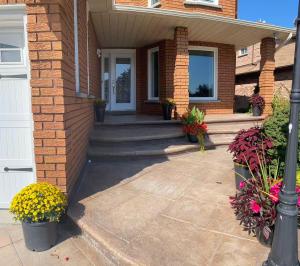 a front porch of a house with flowers at Master bedroom suite on the 2nd floor, city center in Mississauga