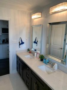 a bathroom with two sinks and a large mirror at Master bedroom suite on the 2nd floor, city center in Mississauga