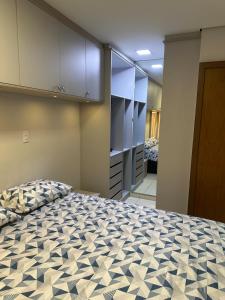 a bedroom with a large bed in a room at Apartamento em Porto Velho in Porto Velho