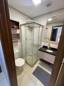 a bathroom with a glass shower and a toilet at Apartamento em Porto Velho in Porto Velho