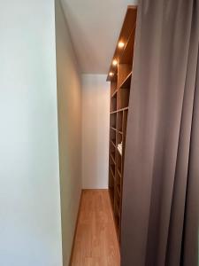 a hallway with a book shelf and a curtain at The Sunny Spot in Sunny Beach +25 photos