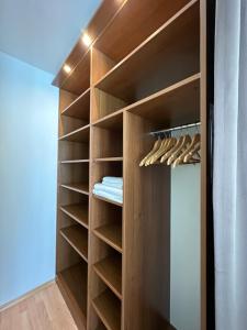 a walk in closet with wooden shelves at The Sunny Spot in Sunny Beach