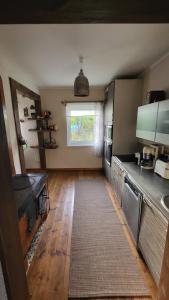 a kitchen with a wooden floor and a window at Private house in Kristiine in Tallinn
