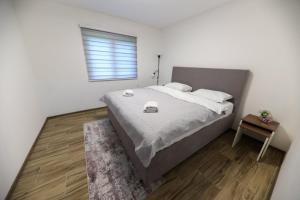 a bedroom with a large bed and a window at Holiday Residence Šehić in Visoko
