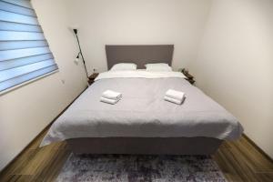 a bedroom with a bed with two pillows on it at Holiday Residence Šehić in Visoko