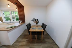 a kitchen and dining room with a wooden table and chairs at Holiday Residence Šehić in Visoko