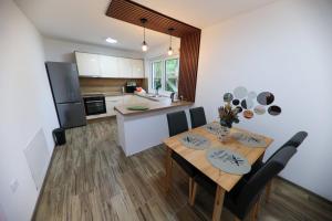 a kitchen and dining room with a table and chairs at Holiday Residence Šehić in Visoko