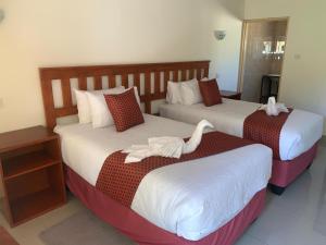 Un pat sau paturi într-o cameră la Rosewood Safari Cottages