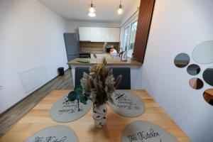 a kitchen with a table with a vase on it at Holiday Residence Šehić in Visoko