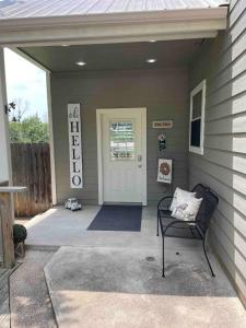 a front porch of a house with a door and a chair at The Nest 1 Bedroom Suite 12 min from Magnolia in Bellmead