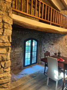 a dining room with a table and a stone wall at Masiadenjust in Rojals