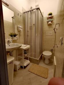 a bathroom with a shower and a toilet and a sink at Mondello Sea House in Palermo +19 photos