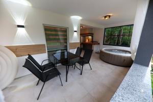a dining room with a table and chairs and a tub at Holiday Residence Šehić in Visoko
