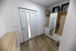 an empty room with a door and a wooden floor at Holiday Residence Šehić in Visoko