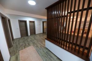 a room with a staircase with wooden railings at Holiday Residence Šehić in Visoko